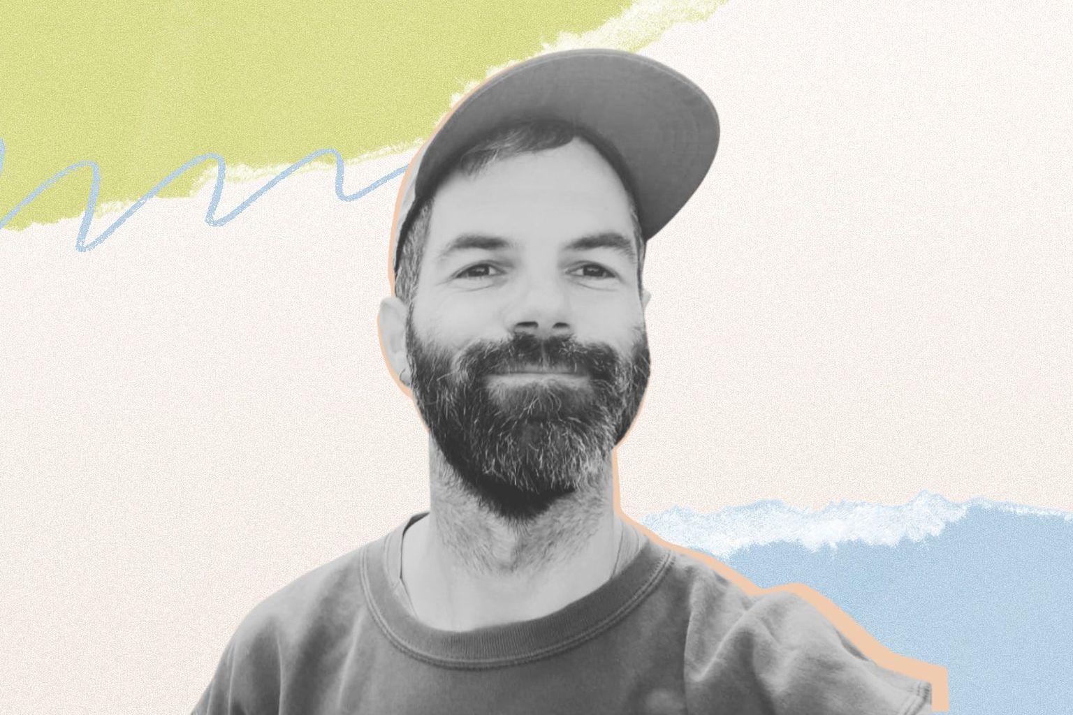Smiling man with a beard and cap against a colorful, abstract background of pastel shapes.