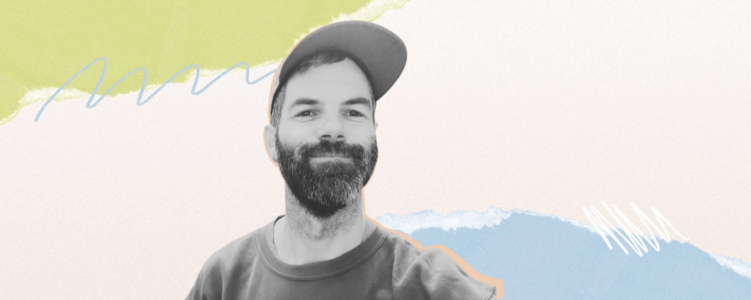 Smiling man with a beard and cap against a colorful, abstract background of pastel shapes.