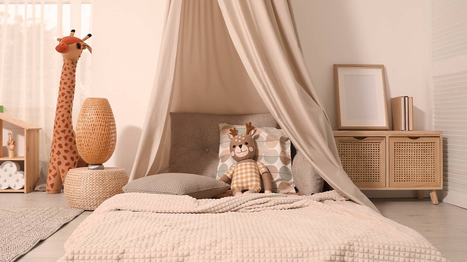 Gemütliches Kinderzimmer mit Baldachinbett, Giraffenspielzeug und Dekokissen. Warme, neutrale Farben schaffen eine beruhigende Atmosphäre.