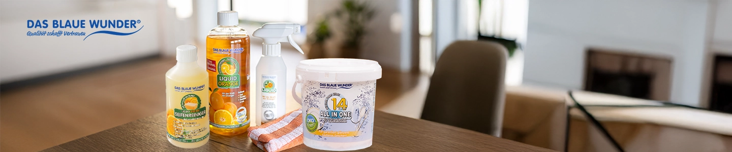 Das Blaue Wunder cleaning products displayed on a wooden table in a bright, modern living room setting.