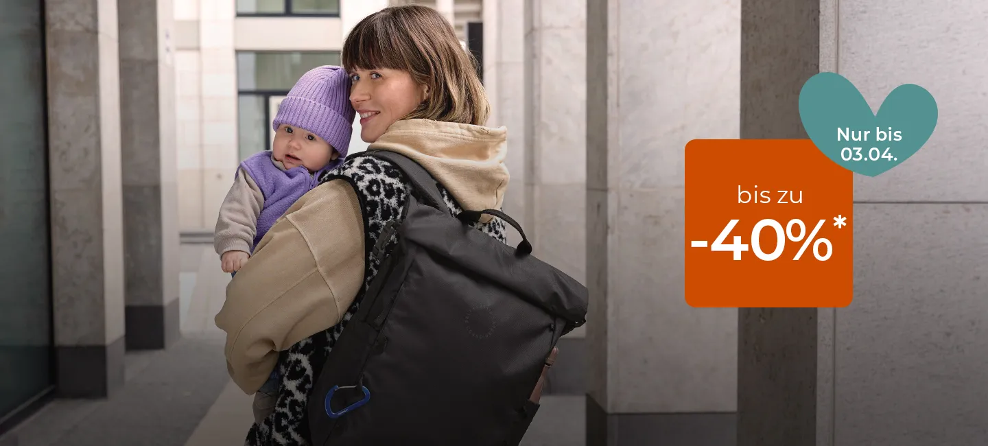 Frau mit Baby, lila Hut und schwarzer Tasche. Rabatttext: „bis zu -40%* Nur bis 03.04.“