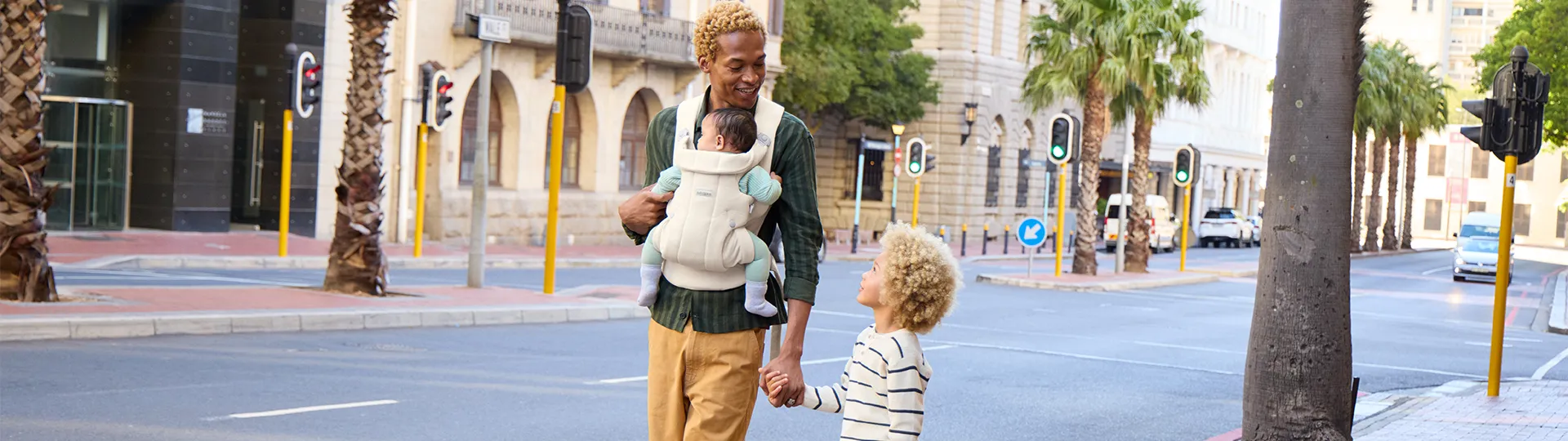 Ein Vater spaziert friedlich mit seinen zwei Kindern durch die Stadt.
