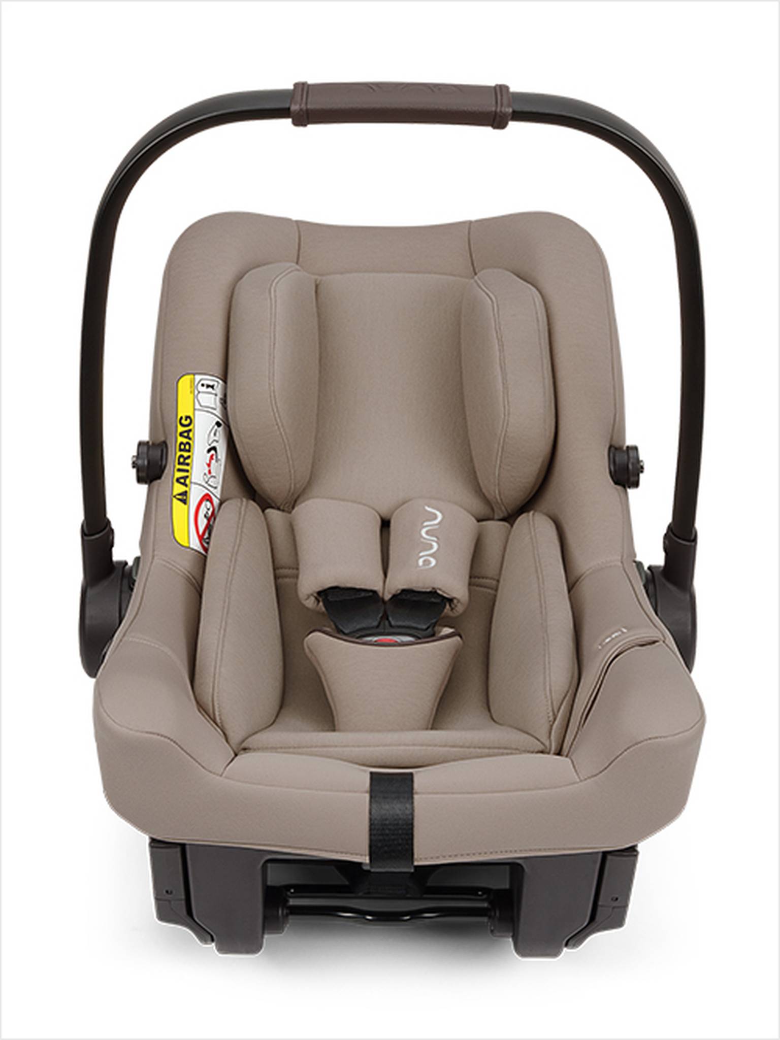 Ein beigefarbener Kindersitz mit schwarzem Griff, gepolsterter Innenausstattung, verstellbaren Gurten und einem Airbag-Warnhinweis an der Seite.