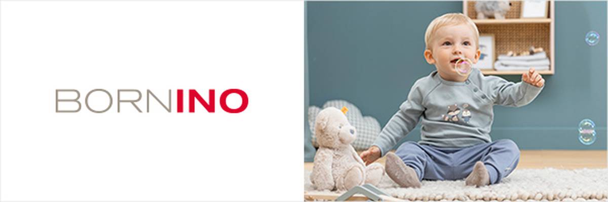 Zwei Kleinkinder sitzen auf einem Teppich und spielen mit Seifenblasen, umgeben von Spielzeug. „BORNINO“-Logo in der Mitte.