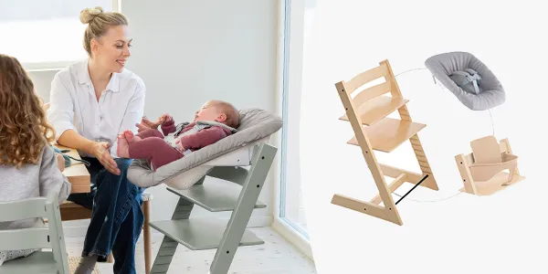 Eine Frau interagiert mit einem Baby auf einem Stuhl. In der Nähe ist ein mehrstufiger Hochstuhl aus Holz zu sehen, der seine Vielseitigkeit und Anpassungsfähigkeit unterstreicht.
