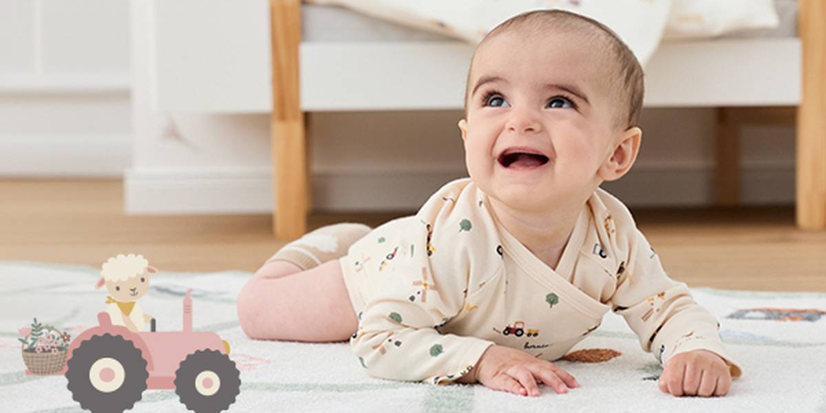 Baby mit langarm Body krabbelt auf dem Boden