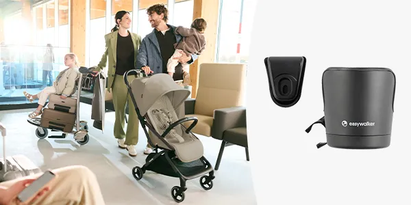 Familie mit Kinderwagen, Vater hält ein Kind, daneben ein Kinderwagenzubehör und ein Getränkehalter vor weißem Hintergrund.