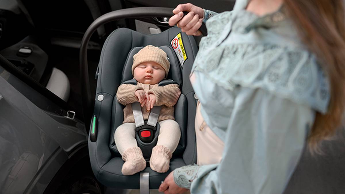 Ein Kind ist in einem Kindersitz angeschnallt.
