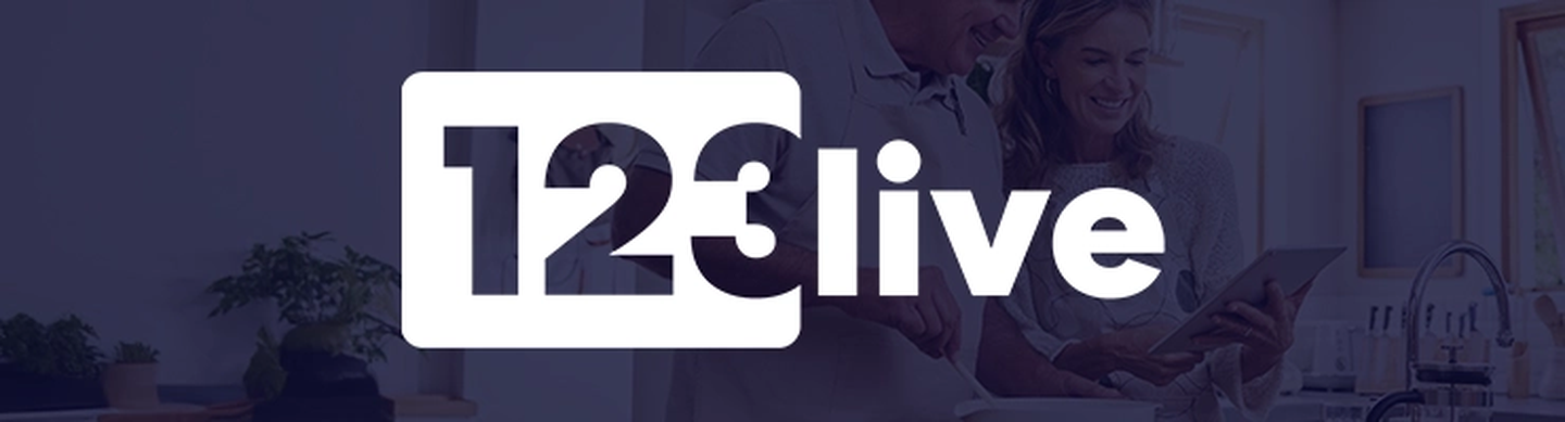 Logo with "123 live" in bold white text over a background of a smiling couple using a tablet in a kitchen.