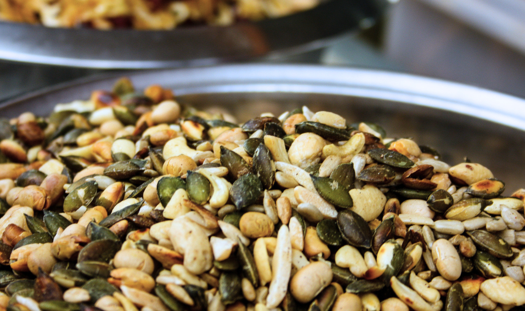 A close-up of various roasted seeds and kernels