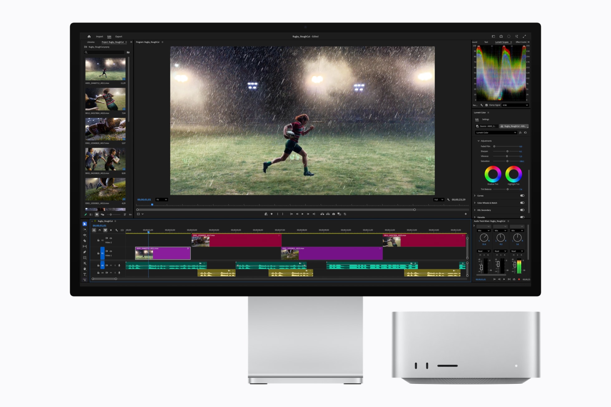 Computer monitor displaying video editing software with footage of an athlete running on a field, alongside a compact Mac Studio M5 Ultra