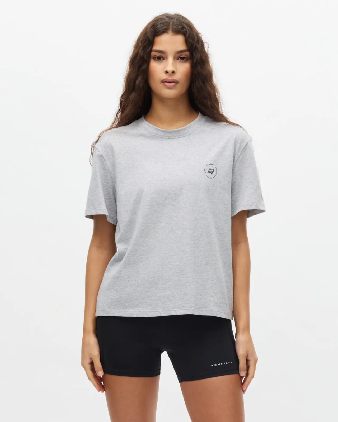Woman in grey t-shirt a black bike shorts.
