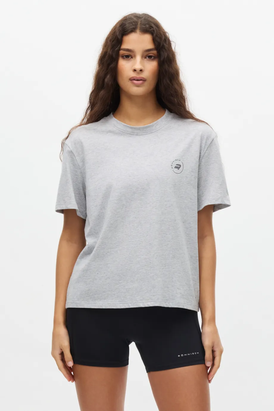 Woman in grey t-shirt a black bike shorts.