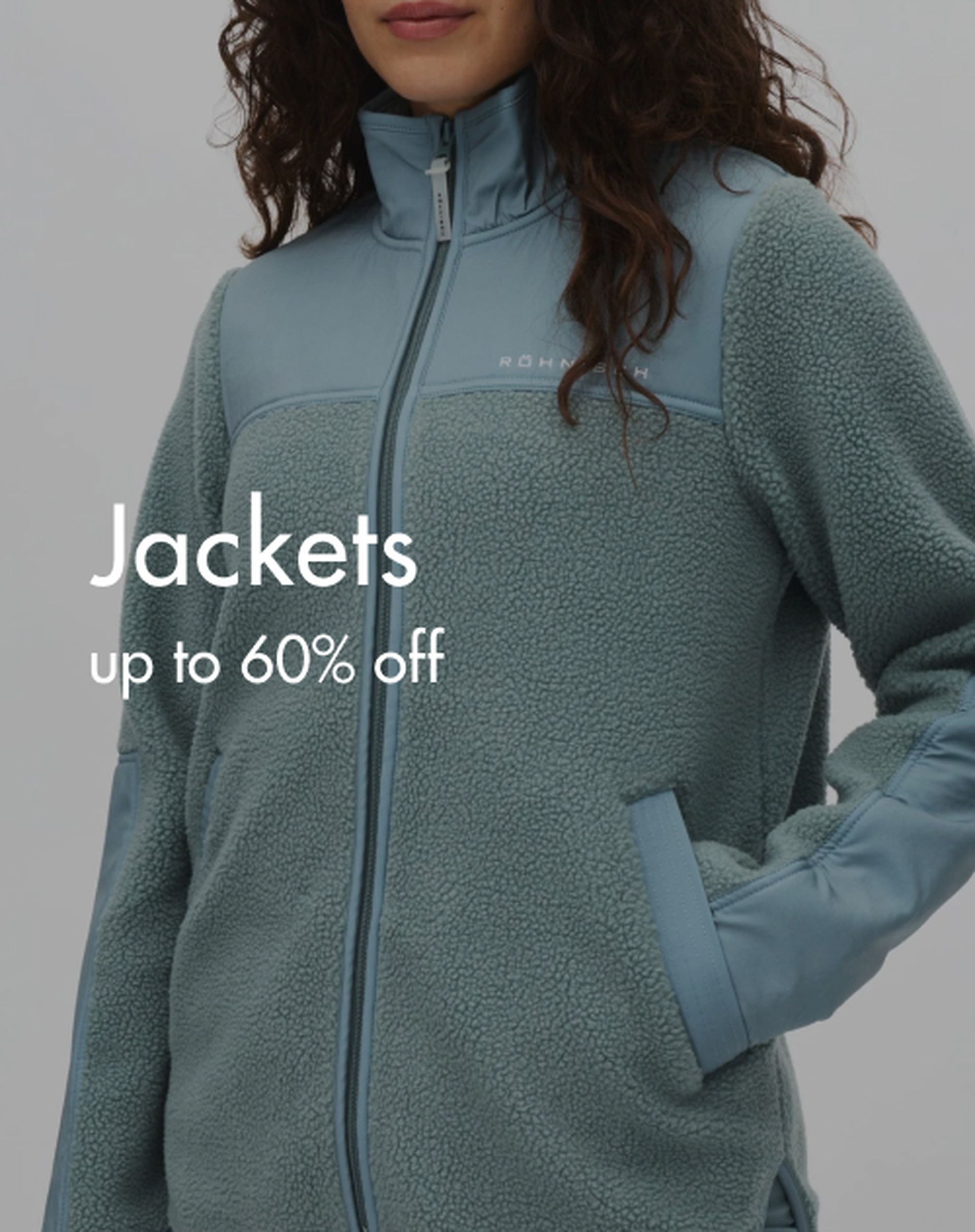 Woman wearing a light blue zip-up fleece jacket with sale text: "Jackets up to 60% off" on the side.