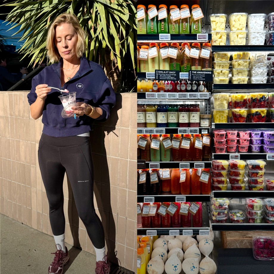 Person eating yogurt outside a market next to a shelf stocked with colorful juices, fresh fruits, and coconuts under bright lighting.