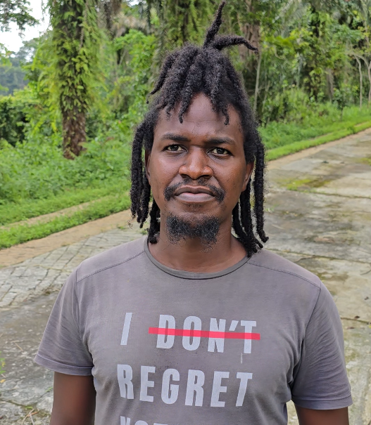 A man standing infront of a forest