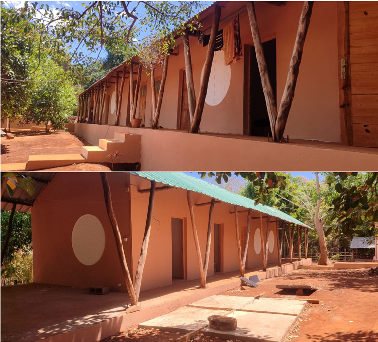 Picture of a field station in Ankarafa - single-storey building with wooden pillars and a green tin roof in the African forest.