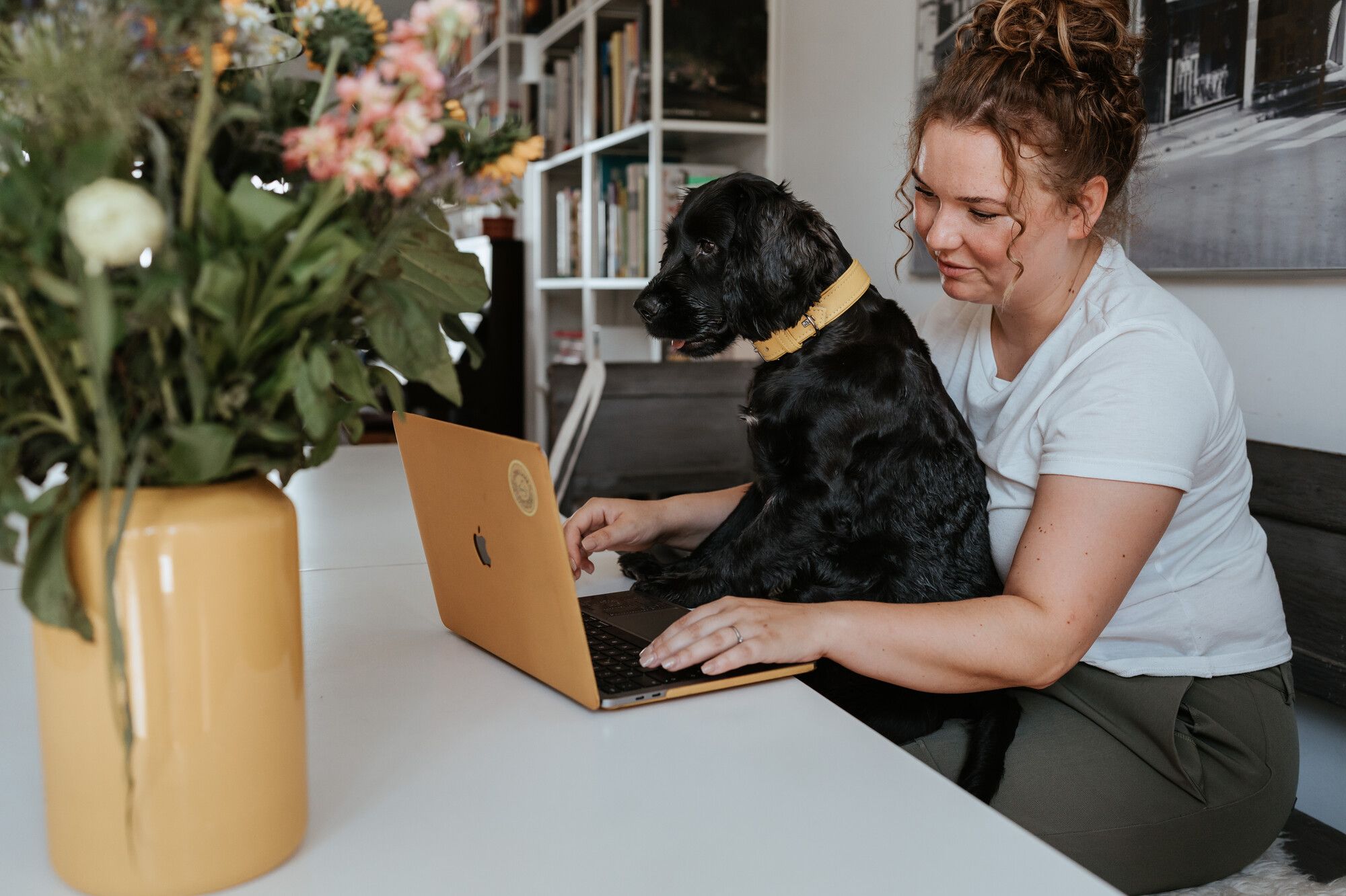 Woman with dog on a laptop