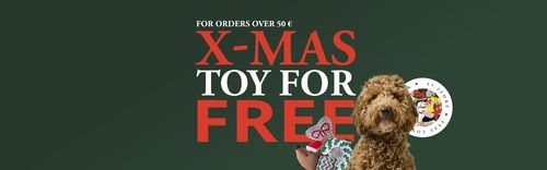 Dark green banner reading "X-MAS Toy free" in bold red/white, with a small curly brown dog holding Christmas toys.
