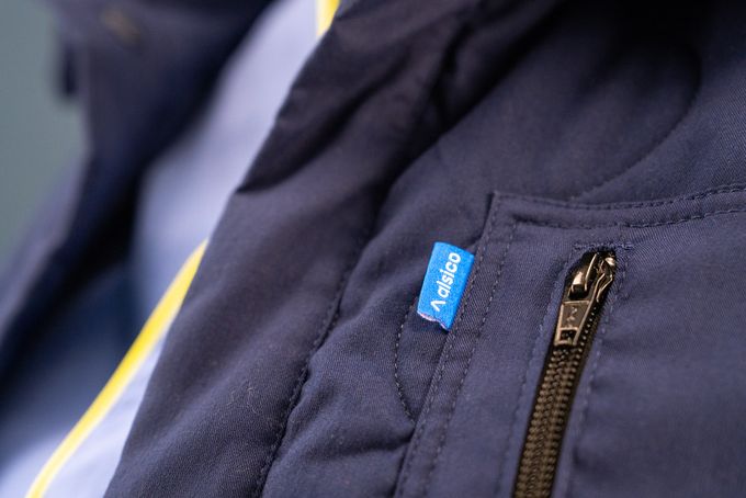 Monviso industrial jacket showcased in a commercial laundry environment, Alsico workwear.