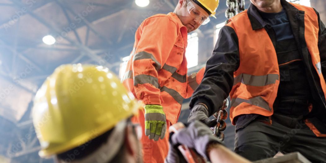 Construction workers wearing Alsico protective gear on-site, promoting safety and durability.