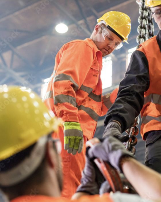 Construction workers wearing Alsico protective gear on-site, promoting safety and durability.