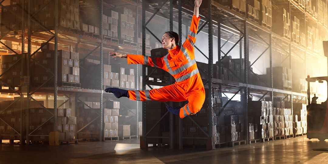 Dancer wearing Alsiflex, showcasing flexible and durable workwear for movement.