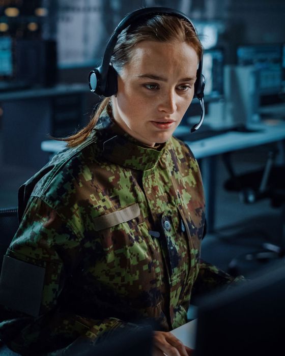 Person wearing fire-resistant PPE gear for hazardous working environments.