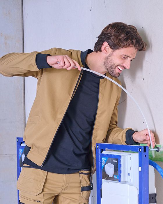 Worker on-site wearing garment samples from Alsico's PPE range.