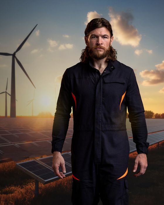 Electrician in Kibo coverall demonstrating Alsico’s protective clothing for electrification work.