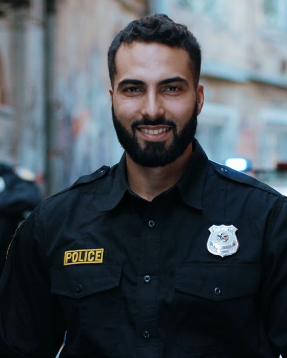 Police worker in PPE on industrial site illustrating Alsico’s protective clothing.
