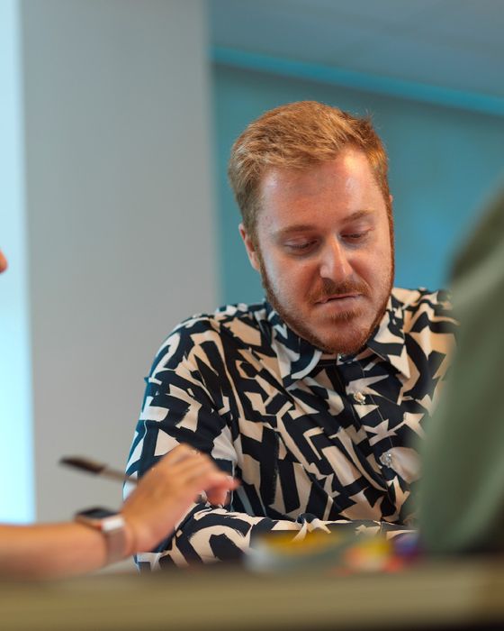 Alsico team in a meeting, discussing workwear solutions.