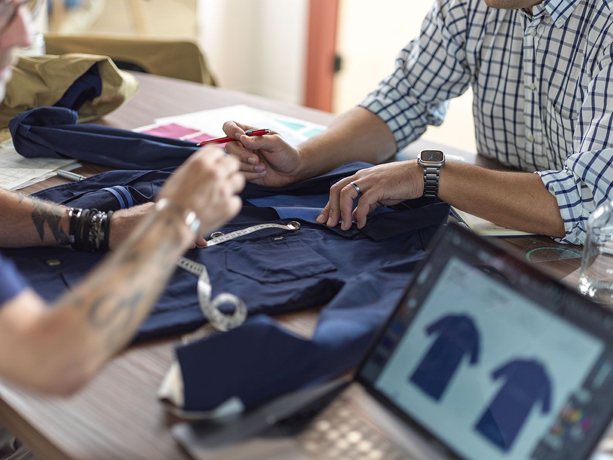 Fashion designers collaborating on workwear innovation and sustainable clothing design.