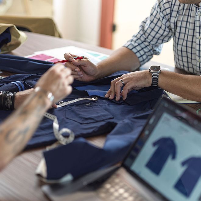 Fashion designers collaborating on workwear innovation and sustainable clothing design.