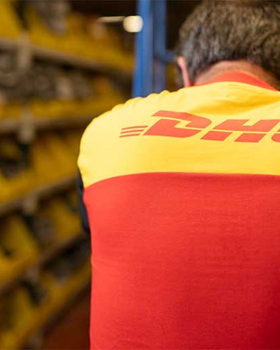 DHL worker from behind, showcasing branded workwear and logistics uniforms.