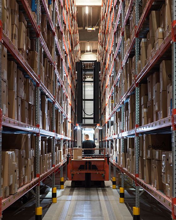 Interior of Alsico Belgium warehouse with equipment and storage.