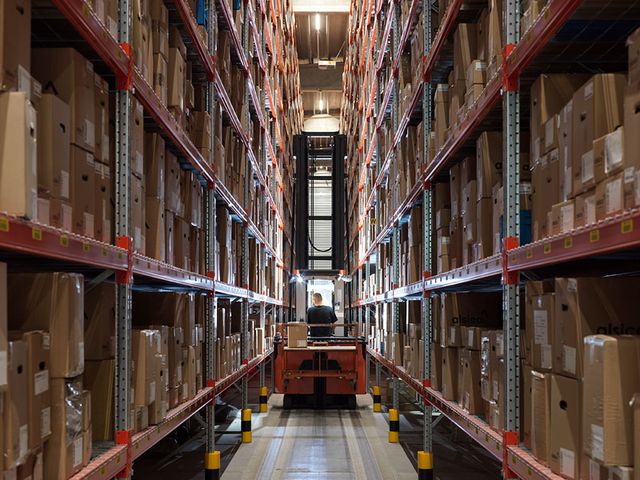 Interior of Alsico Belgium warehouse with equipment and storage.
