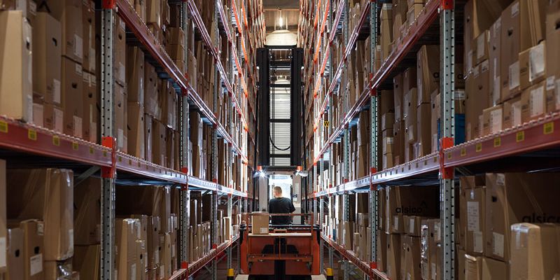 Interior of Alsico Belgium warehouse with equipment and storage.