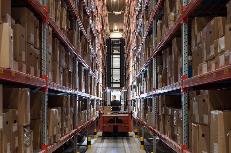 Interior of Alsico Belgium warehouse with equipment and storage.