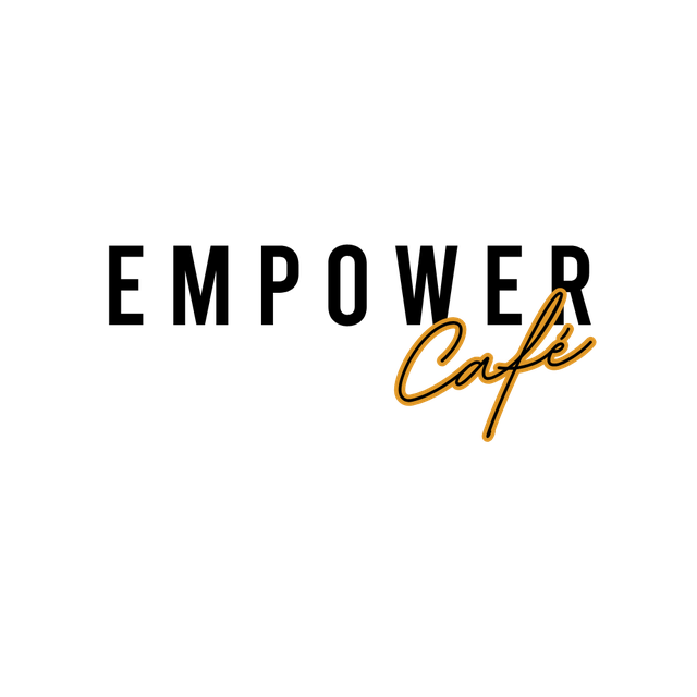 Neon sign reading "Café" in cursive font with a warm amber glow against a black background.