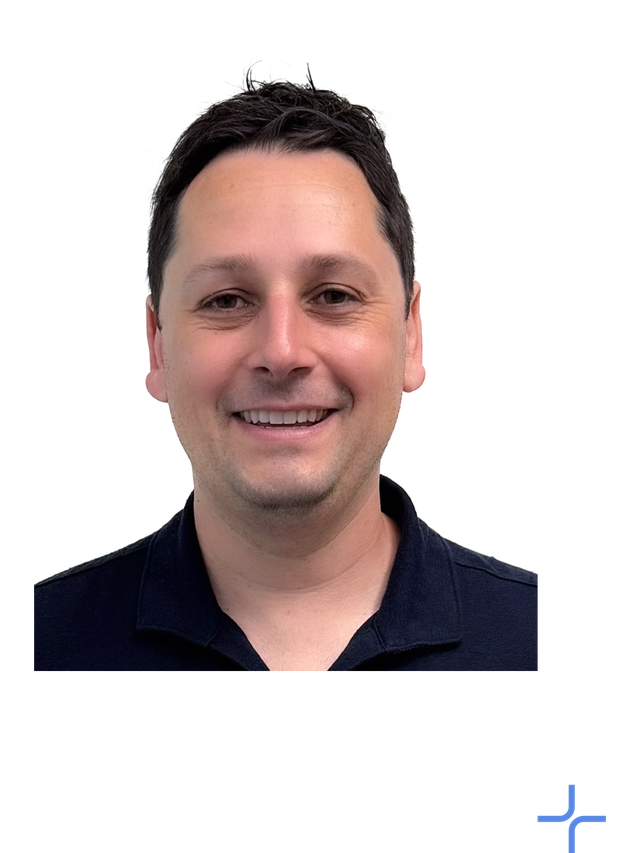 Dan Berger wears dark blue button up shirt and smiles at the camera.