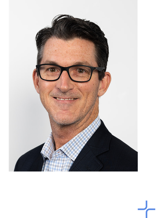 Kevin Zellmer wears a dark suit coat and light colour plaid shirt.