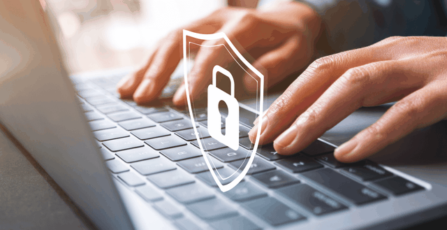 Hands typing on laptop with graphic of padlock