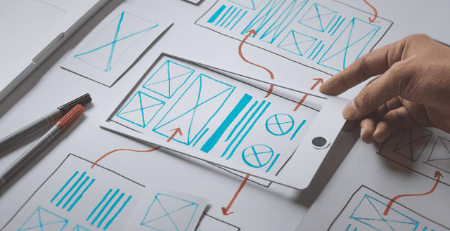 Picture of hand picking up diagram drawn on paper
