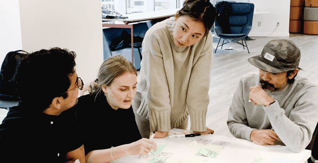 A group of people around a table, working