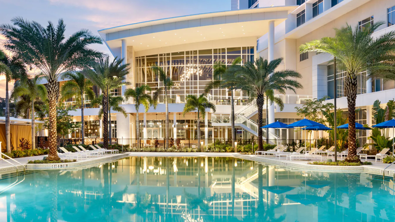 Upscale hotel with pool and palm trees