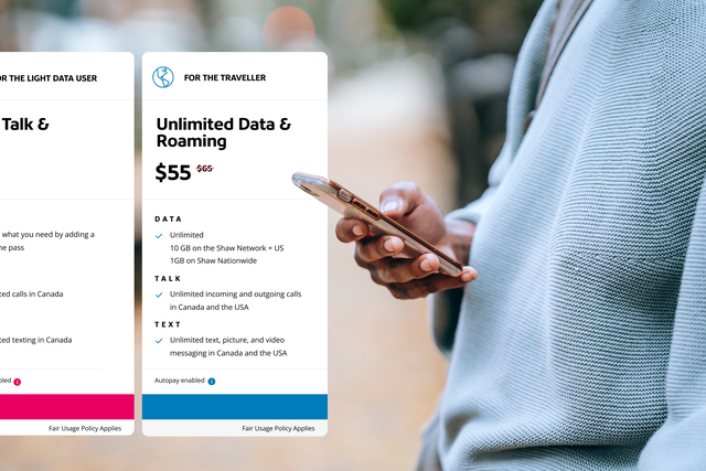 Man looking down at his smartphone with plan pricing on display