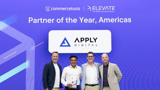 Four men standing together, smiling, in front of a purple backdrop with commercetools and Elevate logos, the text "Partner of the Year, Americas" and the Apply Digital logo.