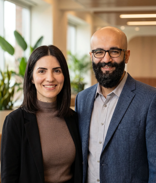 Portrait of a woman and man smiling at the camera.