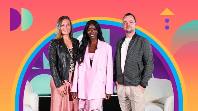 Three people smiling, standing in front of a colorful, geometric background with a rainbow arch. The middle person wears a pink outfit.